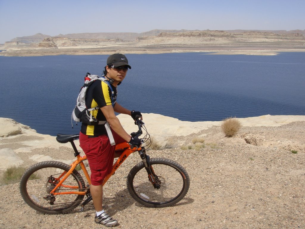 man riding bike by lake powell